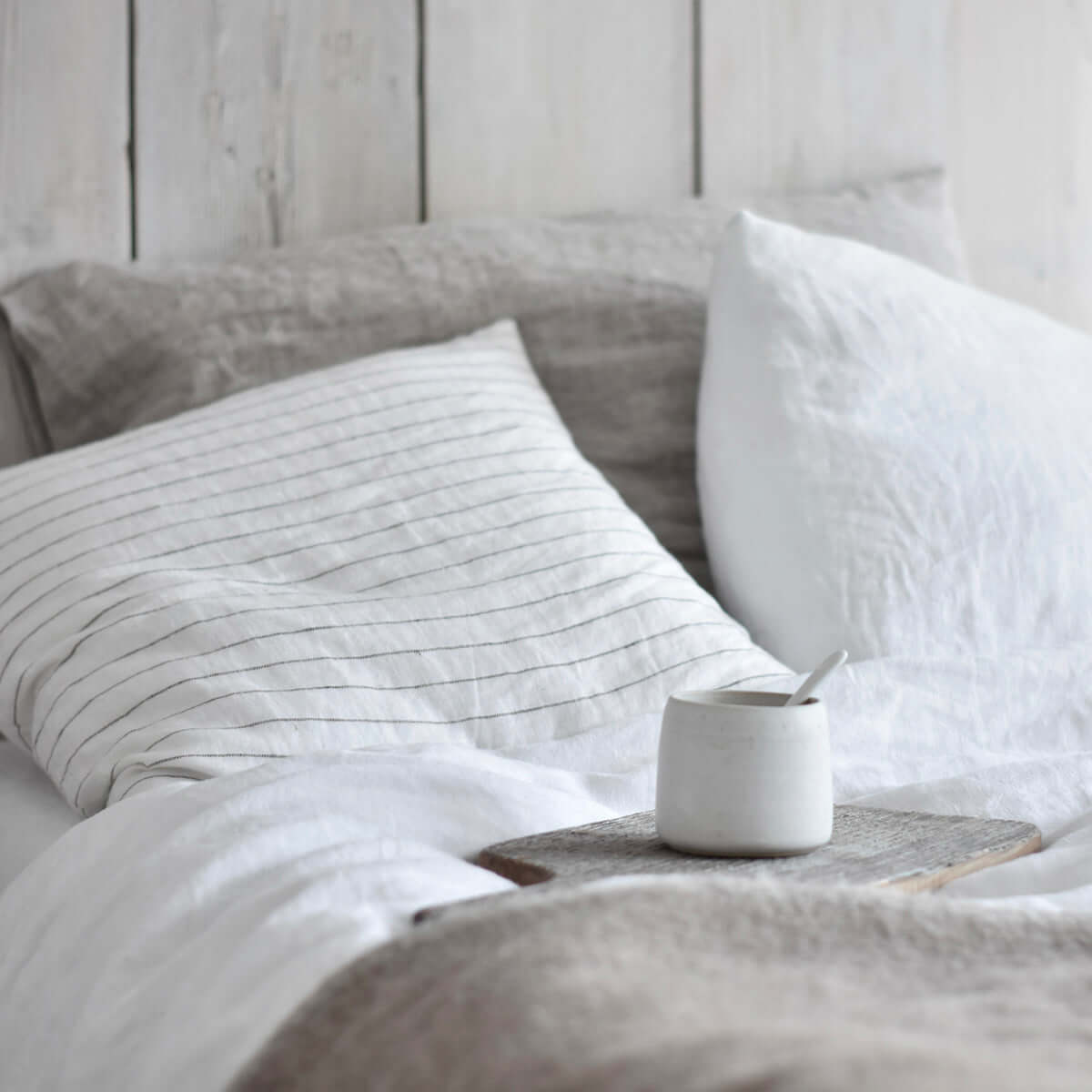 White linen duvet cover with brown linen pillowcase.